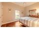 Bright bedroom features a ceiling fan, window with outside view, and patterned bedding at 6049 Sabal Hammock Cir, Port Orange, FL 32128