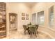 Cozy dining area with a round table, green chairs, and natural light from the window at 6049 Sabal Hammock Cir, Port Orange, FL 32128