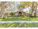 Charming single-story home featuring a manicured lawn and mature trees for shade and curb appeal at 6049 Sabal Hammock Cir, Port Orange, FL 32128