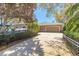 Wide driveway leading to a multi-car garage, framed by manicured hedges and mature trees at 6049 Sabal Hammock Cir, Port Orange, FL 32128
