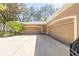 Attached three-car garage showing parking, a wide driveway, and some landscaping at 6049 Sabal Hammock Cir, Port Orange, FL 32128