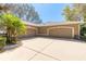 Three-car garage offering ample parking space, surrounded by lush landscaping and a well-maintained driveway at 6049 Sabal Hammock Cir, Port Orange, FL 32128