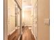 Hallway displaying hardwood floors, white doors, a skylight, and a mirrored closet at 6049 Sabal Hammock Cir, Port Orange, FL 32128