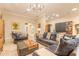 Spacious living room showcasing a cozy sectional, tile floors and modern design at 6049 Sabal Hammock Cir, Port Orange, FL 32128