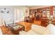 Cozy home office with custom built-ins, hardwood floors and seating area at 6049 Sabal Hammock Cir, Port Orange, FL 32128