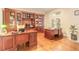 Office boasts hardwood floors, custom shelving, and a well-lit workspace at 6049 Sabal Hammock Cir, Port Orange, FL 32128