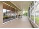 View of outdoor grill and screened-in patio featuring multiple sliding glass doors at 6049 Sabal Hammock Cir, Port Orange, FL 32128
