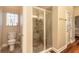 Walk-in shower with a glass door, a seating ledge, and tiled walls and floors at 6049 Sabal Hammock Cir, Port Orange, FL 32128