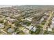 This aerial view shows a home in a neighborhood with mature landscaping at 606 Yupon Ave, New Smyrna Beach, FL 32169