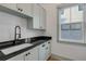 Mudroom with shaker cabinets, black countertops, matte faucet, and bright window at 606 Yupon Ave, New Smyrna Beach, FL 32169