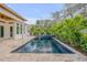 Beautiful pool area with lush landscaping that provides a relaxing and private retreat at 606 Yupon Ave, New Smyrna Beach, FL 32169