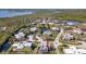 Aerial view of charming waterfront community with mature landscaping and water views at 61 Cedar Dunes Dr, New Smyrna Beach, FL 32169