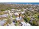 Aerial view of a residential community with well-maintained homes, mature trees, and proximity to the ocean at 61 Cedar Dunes Dr, New Smyrna Beach, FL 32169