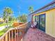 Comfortable brick balcony with views of palm trees and neighborhood at 61 Cedar Dunes Dr, New Smyrna Beach, FL 32169