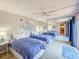 Bedroom with two twin beds featuring a large mirrored closet and ensuite bathroom at 61 Cedar Dunes Dr, New Smyrna Beach, FL 32169