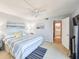 Bright bedroom features an ensuite bathroom, ceiling fan, and beach themed décor at 61 Cedar Dunes Dr, New Smyrna Beach, FL 32169