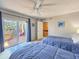 Bedroom with two twin beds featuring a balcony and ensuite bathroom at 61 Cedar Dunes Dr, New Smyrna Beach, FL 32169