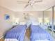 Bedroom with two twin beds featuring lamps and beach themed decor at 61 Cedar Dunes Dr, New Smyrna Beach, FL 32169