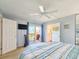 Bright bedroom features ensuite bathroom and private balcony with ceiling fan at 61 Cedar Dunes Dr, New Smyrna Beach, FL 32169