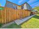 View of home with wooden privacy fence and balcony above gate at 61 Cedar Dunes Dr, New Smyrna Beach, FL 32169