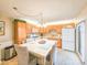 Bright kitchen with wooden cabinets, modern appliances, a spacious island, and tile flooring, perfect for cooking at 61 Cedar Dunes Dr, New Smyrna Beach, FL 32169