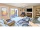 Inviting living room with a fireplace, comfortable seating, and a sliding door that opens to an outdoor patio at 61 Cedar Dunes Dr, New Smyrna Beach, FL 32169