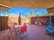 Fenced patio with brick floor, an outdoor table and chairs, and a storage shed at 61 Cedar Dunes Dr, New Smyrna Beach, FL 32169