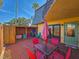 Fenced patio with brick floor, an outdoor table, an umbrella, and a storage shed at 61 Cedar Dunes Dr, New Smyrna Beach, FL 32169