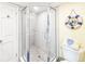 Bathroom featuring corner glass shower and beach themed décor at 61 Cedar Dunes Dr, New Smyrna Beach, FL 32169