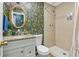 Stylish bathroom featuring designer wallpaper, tiled shower, and modern vanity at 612 Cedar Park Dr, Daytona Beach, FL 32114
