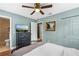 Bright bedroom with a ceiling fan, tv, and an ensuite bathroom at 612 Cedar Park Dr, Daytona Beach, FL 32114