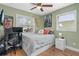 Comfortable bedroom with a ceiling fan, hardwood floors, and plenty of natural light at 612 Cedar Park Dr, Daytona Beach, FL 32114