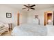 Inviting bedroom with a ceiling fan, cozy seating area, and neutral decor, providing a comfortable retreat at 612 Mount Olympus Blvd, New Smyrna Beach, FL 32168