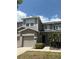 Two story townhome with a neutral color palette, covered entryway and attached garage at 612 Mount Olympus Blvd, New Smyrna Beach, FL 32168
