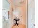 Hallway featuring a charming table with a lamp, with views into another room creating an inviting entrance at 612 Mount Olympus Blvd, New Smyrna Beach, FL 32168