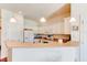 Bright kitchen with white cabinets, modern appliances, and an open view of the rest of the home at 612 Mount Olympus Blvd, New Smyrna Beach, FL 32168