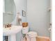 Neat half bathroom featuring a modern sink and toilet, perfect for guests at 612 Mount Olympus Blvd, New Smyrna Beach, FL 32168