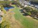 Aerial view of a beautiful golf course community featuring large homes, ponds, and lush green fairways at 6456 Cypress Springs Pkwy, Port Orange, FL 32128