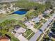 Aerial view of a home with a pool alongside a golf course and pond in a residential neighborhood at 6456 Cypress Springs Pkwy, Port Orange, FL 32128