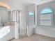 Primary bathroom featuring a tub and a glass shower at 6456 Cypress Springs Pkwy, Port Orange, FL 32128