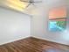 Bright bedroom with hardwood floors, modern ceiling fan, and a window offering natural light at 6456 Cypress Springs Pkwy, Port Orange, FL 32128