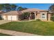 Charming single-story home with lush green lawn and arched entryway, located in a desirable neighborhood at 6456 Cypress Springs Pkwy, Port Orange, FL 32128