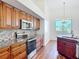 Kitchen featuring cherry cabinets, stainless appliances, and tile backsplash at 6456 Cypress Springs Pkwy, Port Orange, FL 32128