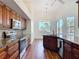 Spacious kitchen features stainless appliances, wood cabinetry and granite counters at 6456 Cypress Springs Pkwy, Port Orange, FL 32128