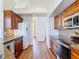 Galley style kitchen with stainless appliances, tile backsplash, and cherry cabinets at 6456 Cypress Springs Pkwy, Port Orange, FL 32128