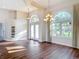Bright living room boasts rich wood floors, high ceilings, decorative lighting, and large arched windows at 6456 Cypress Springs Pkwy, Port Orange, FL 32128