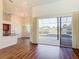 Open-concept living space showcasing wood floors, a partial kitchen view and scenic pool views at 6456 Cypress Springs Pkwy, Port Orange, FL 32128
