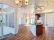 Open floor plan features wood floors, a kitchen island, and plenty of room to entertain at 6456 Cypress Springs Pkwy, Port Orange, FL 32128