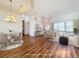 Staged open-concept living area with elegant furniture, chandelier lighting, and seamless outdoor access at 6456 Cypress Springs Pkwy, Port Orange, FL 32128