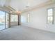 Spacious main bedroom with tray ceiling, carpet, and access to the lanai at 6456 Cypress Springs Pkwy, Port Orange, FL 32128
